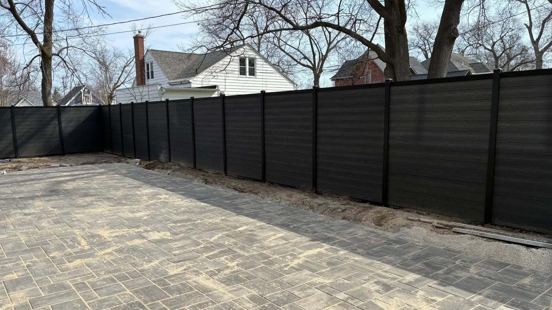 Stained wooden fence installed in Le Roy, MI
